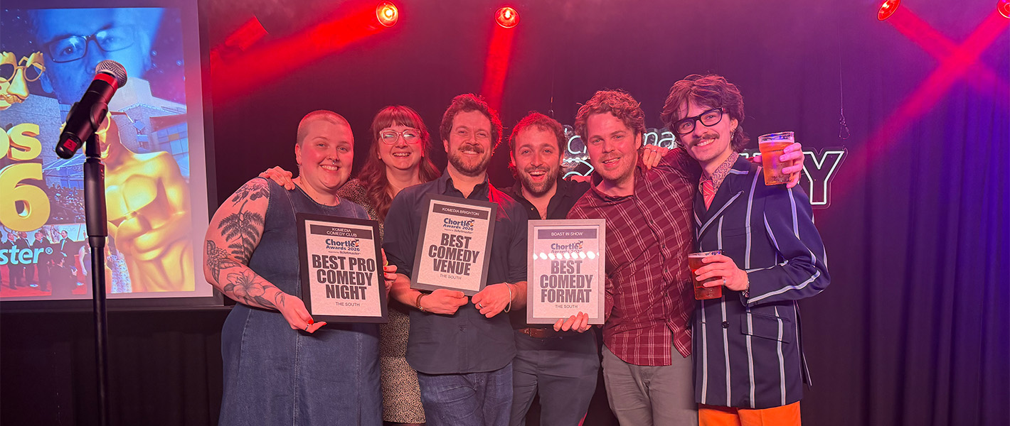 The Komedia team on stage holding certificates.