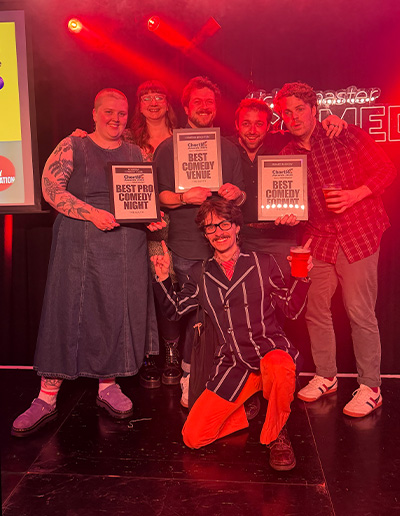 The Komedia team on stage holding certificates.